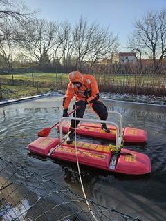 Feuerwehrmann im Überlebensanzug auf dem Eisretter