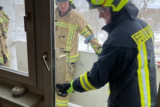 Feuerwehrmänner öffnen Terrassenfenster von außen