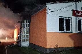 Flammen schlagen aus einem Haus und Rauch kommt raus.