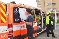 Einsatzleitwagen und Feuerwehrmann steht an der Taktiktafel