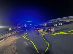 im Vordergrund ist ein Schlauch und Bindemittel zu sehen, im Hintergrund Fahrzeuge
