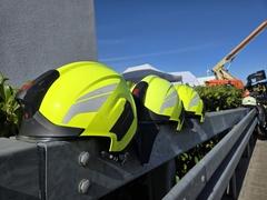 3 gelbe Feuerwehrhelme auf einer Brüstung